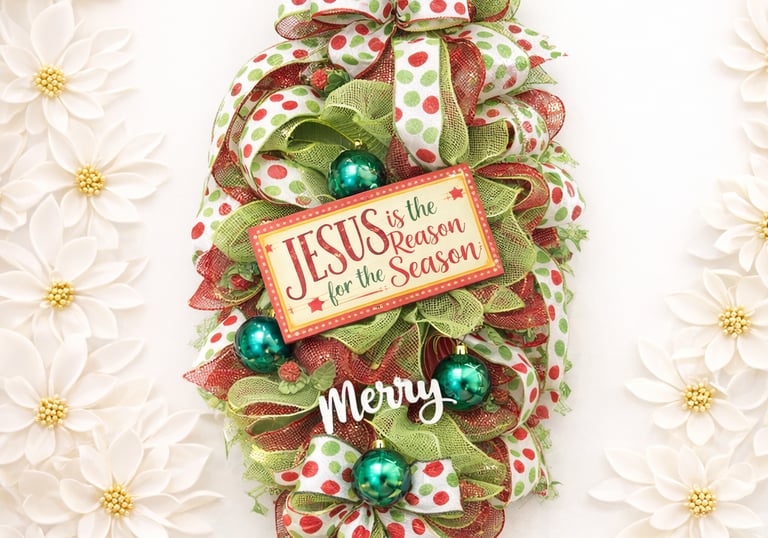 Religious Christmas door swag featuring red and green deco mesh, polka dot ribbons, and a Jesus is the Reason for the Season
