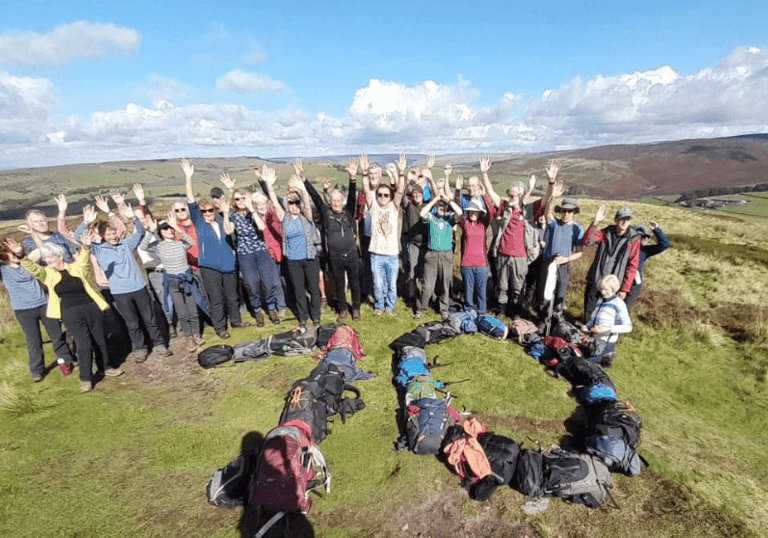 Walkers waving hands in the air to celebrate