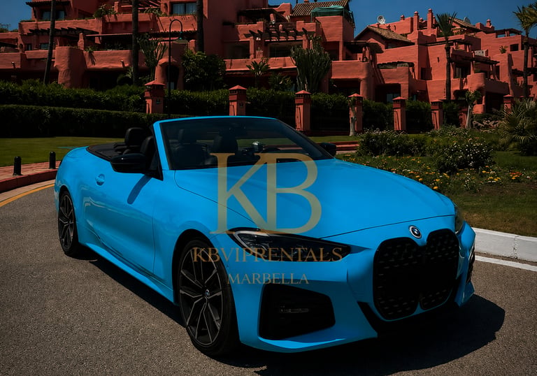 Luxury blue BMW convertible rental parked in front of a pink Marbella resort.