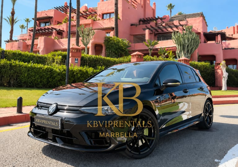 Black Volkswagen Golf R rental car parked in front of a luxury pink resort in Marbella.