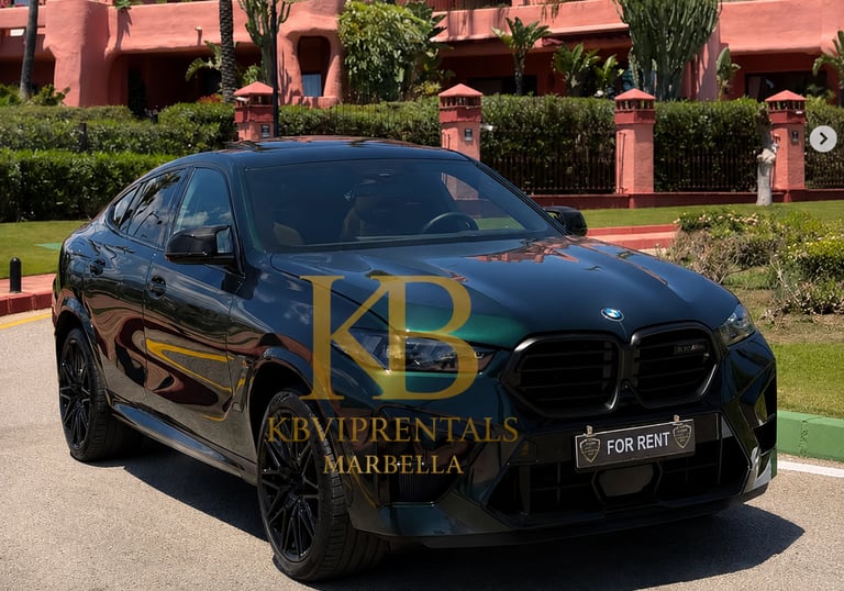 A black BMW X6 luxury SUV for rent parked in front of a pink Mediterranean villa in Marbella.