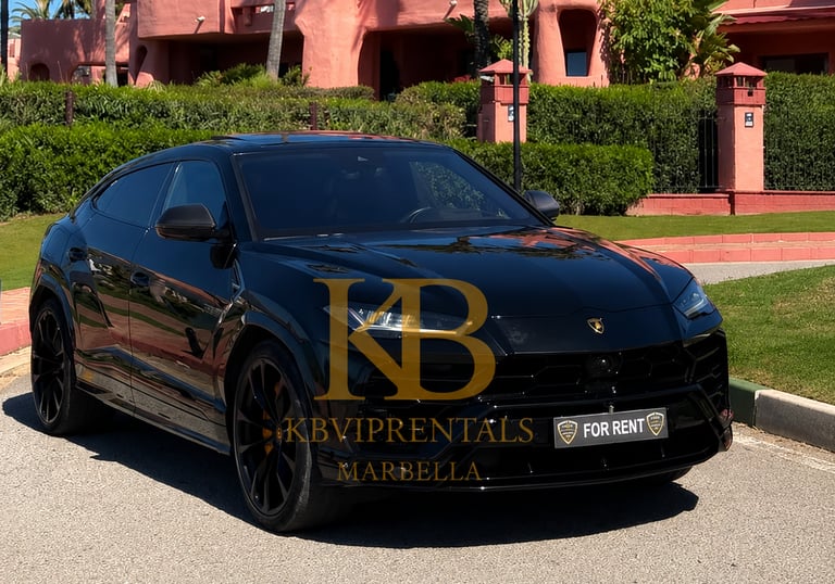 Black Lamborghini Urus luxury SUV rental parked in Marbella near a pink Mediterranean villa.