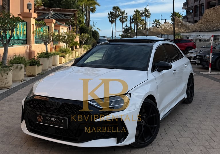 White Audi luxury sports car parked on a sunny street in Marbella for premium vehicle rental services.