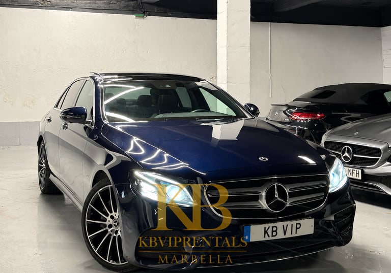 Luxury dark blue Mercedes-Benz E-Class sedan parked in a Marbella VIP rental garage.