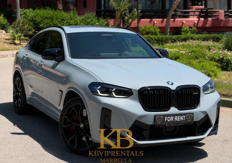 Luxury grey BMW X4 M Competition rental car parked in Marbella on a sunny day.