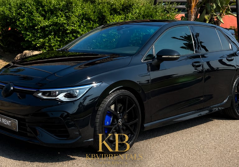 Sleek black Volkswagen Golf R hatchback rental car parked on a sunny street with blue brake calipers.