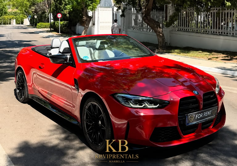 Red BMW M4 convertible luxury car for rent parked on a sunny street in Marbella.