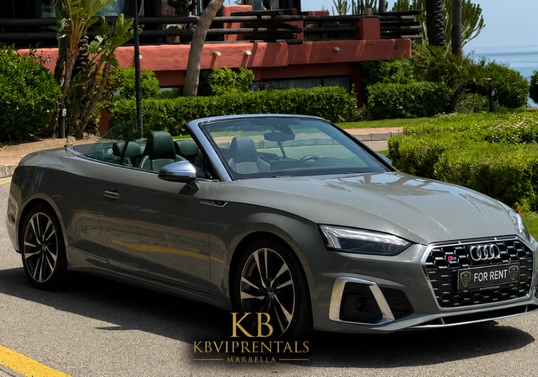 Grey Audi S5 convertible luxury car rental parked on a sunny street in Marbella.