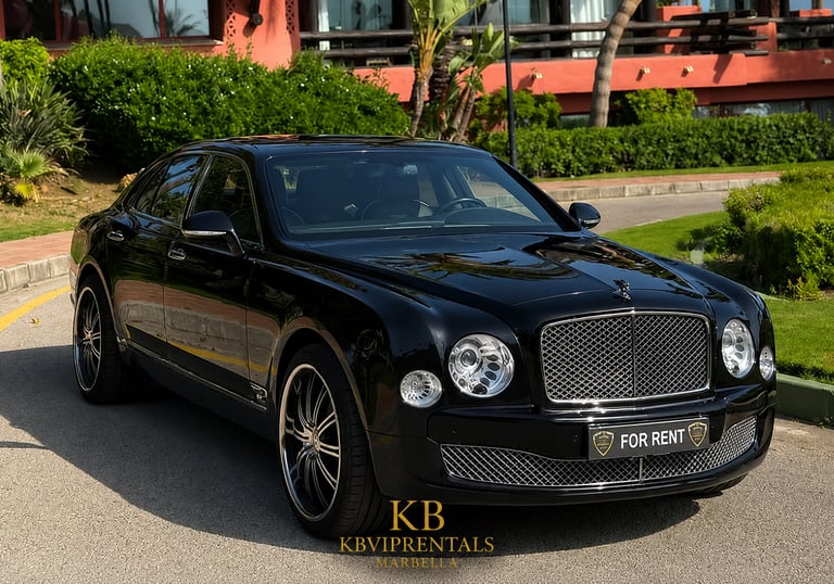 Luxury black Bentley Mulsanne sedan for rent parked at a high-end resort in Marbella.