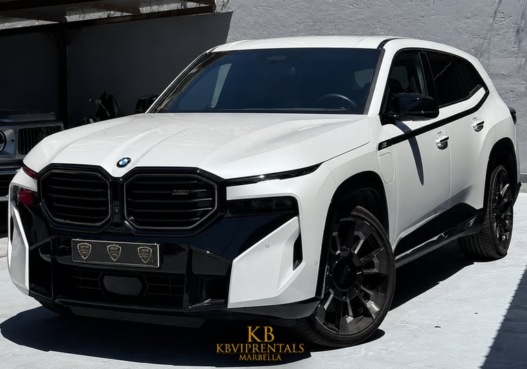 A white BMW XM luxury SUV with black trim parked at KB VIP Rentals in Marbella.
