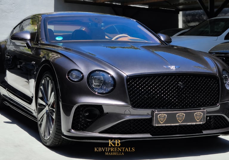 Luxury dark grey Bentley Continental GT rental car parked in Marbella.