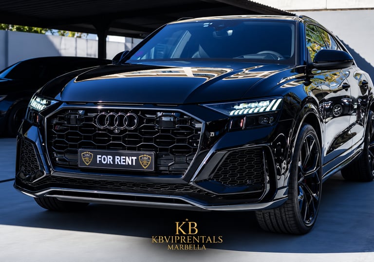 Luxury black Audi RS Q8 rental car parked in Marbella with sleek LED headlights and blacked-out grille.