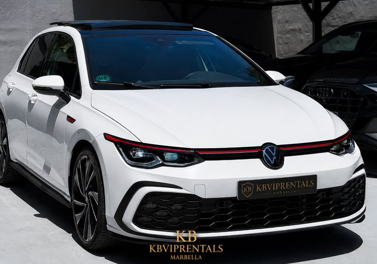 White Volkswagen Golf GTI luxury rental car parked at KB VIP Rentals in Marbella.