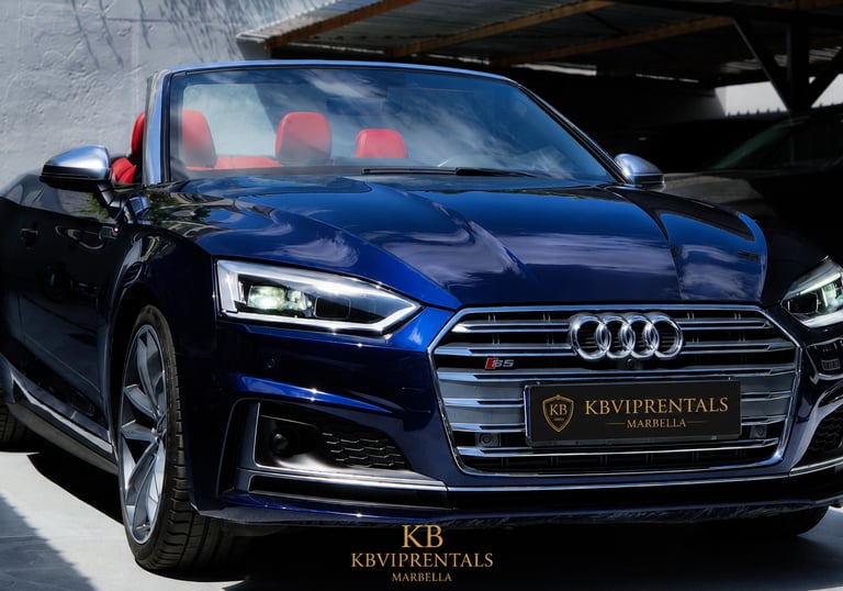 Luxury blue Audi S5 convertible rental with red leather interior parked at KB VIP Rentals Marbella.