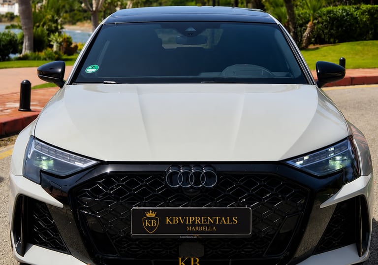 Front view of a white Audi RS3 luxury rental car parked in Marbella with a black honeycomb grille.