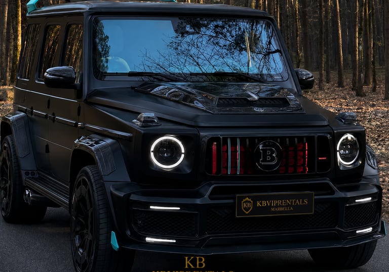 A customized matte black Brabus G-Wagon luxury SUV parked in a forest setting for high-end vehicle rentals.