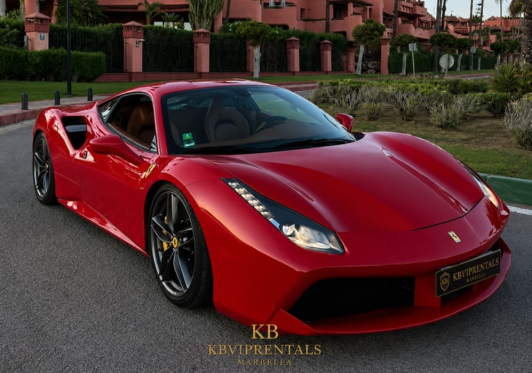 A red Ferrari 488 GTB luxury sports car parked on a road in Marbella, Spain.