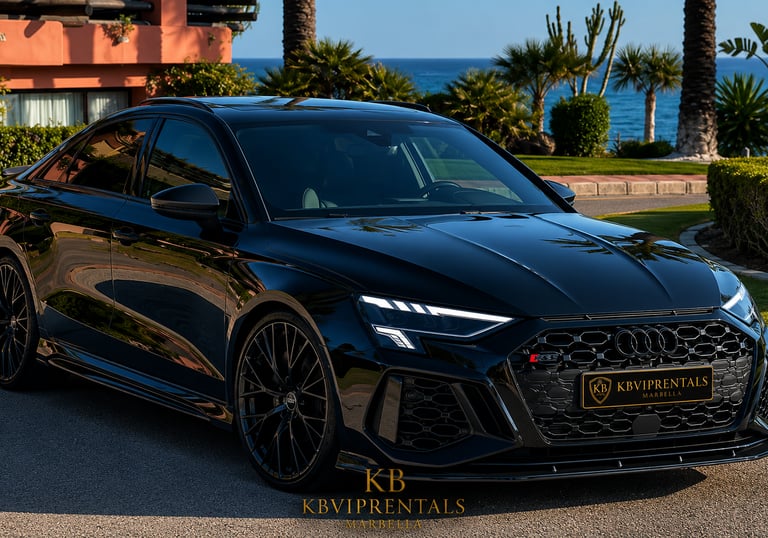 Black Audi RS3 luxury car rental in Marbella parked by the Mediterranean coast with ocean views.