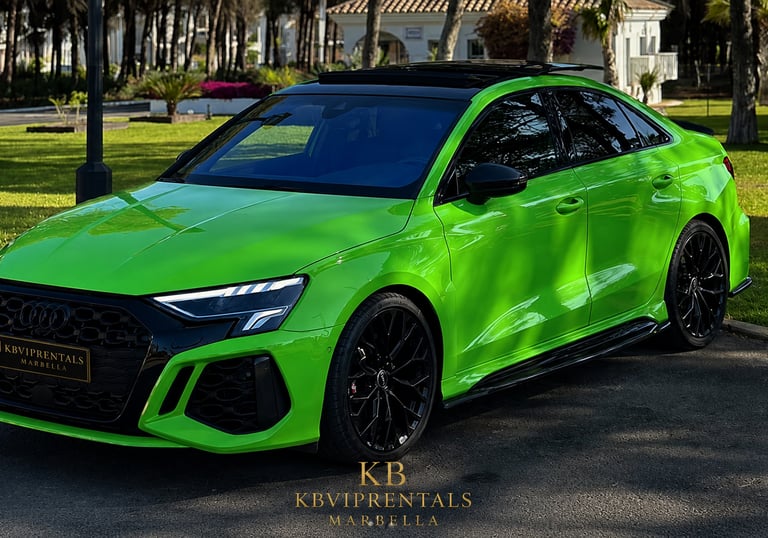 A bright green Audi RS3 luxury sedan parked in a sunny garden setting for KB VIP Rentals in Marbella.