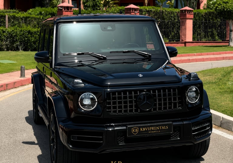 Luxury black Mercedes-Benz G-Class SUV parked at a premium car rental in Marbella.