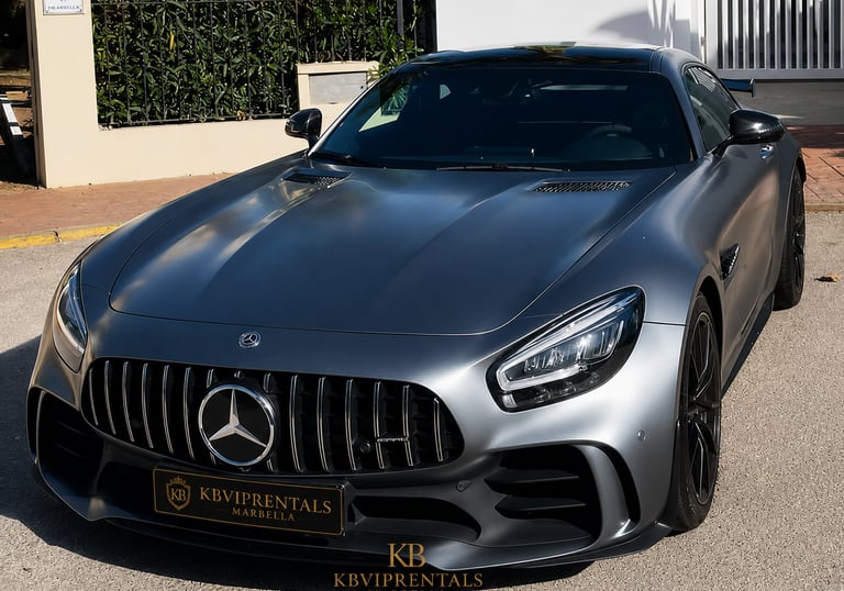Matte grey Mercedes-AMG GT luxury sports car parked outdoors in Marbella.