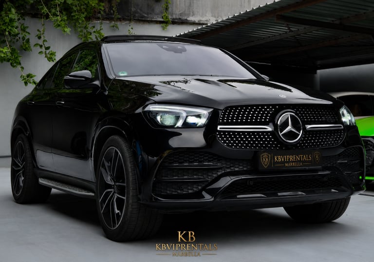 Sleek black Mercedes-Benz GLE Coupe luxury SUV parked at a premium car rental showroom.