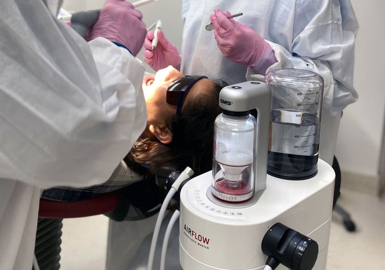 a woman is getting her teeth examined by a dentist
