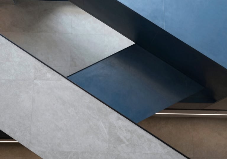 An abstract photograph of a modern staircase inside a financial institution in North America. The composition uses geometric shapes in light grey and steel blue to suggest progress and sophisticated design.