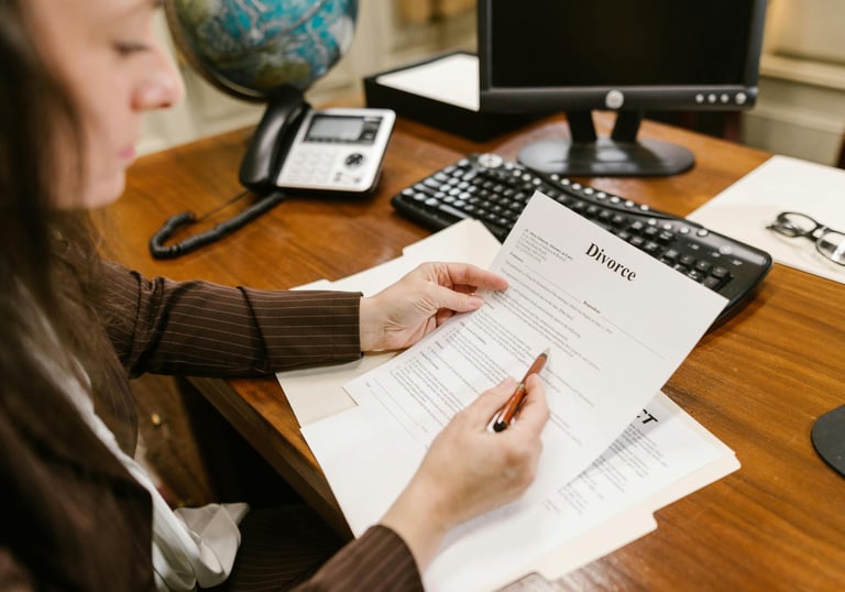 a woman sitting at a desk with a pen and paper