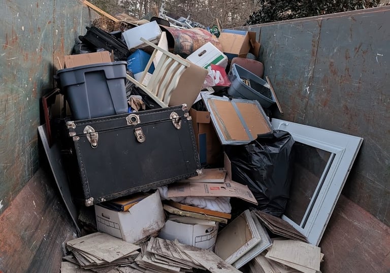 miscellaneous items in dumpster bin
