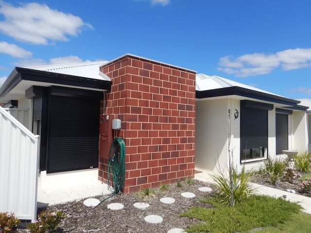 Pre-purchase building inspector assessing home in Perth for defects and safety issues.