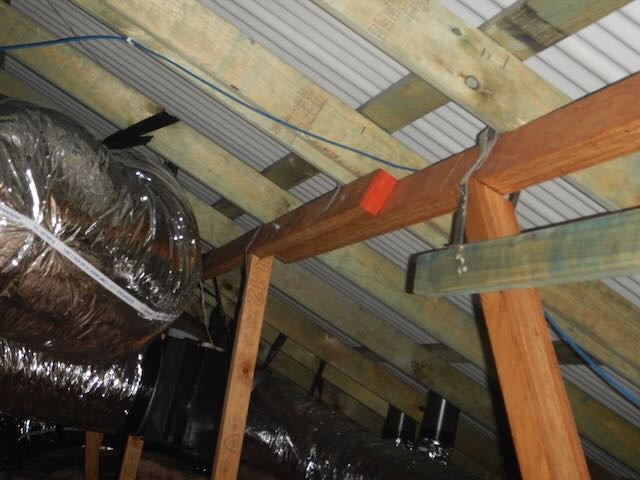 Perth building inspector documenting defects for warranty claim report.