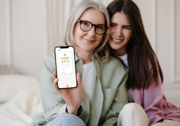 a woman holding a cell phone with a digital loyalty card