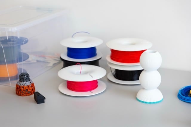 a table with 3d printing spolls and tools