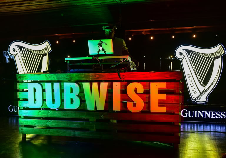 Dubwise logo lit with red yellow and green lights with the Guinness logo placed behind on each side