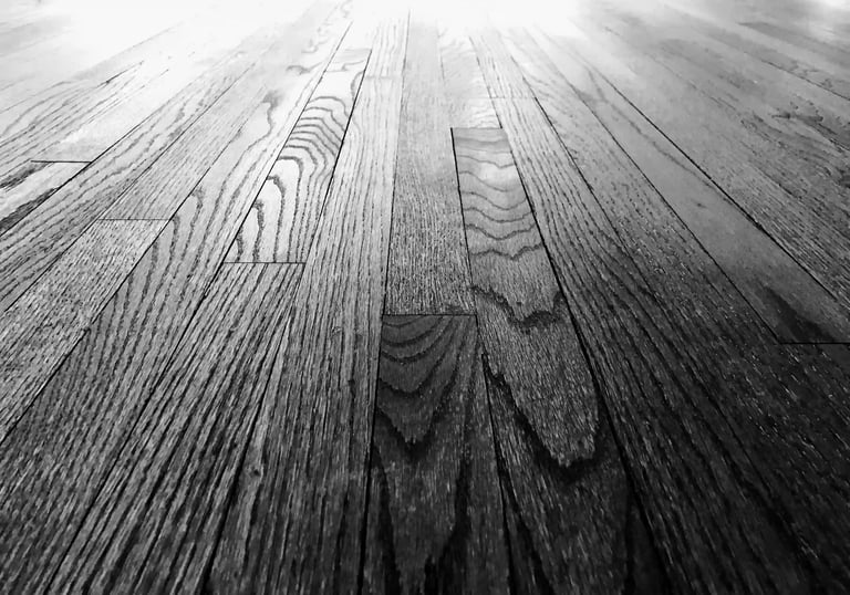 Close up of refinished hardwood floor grain showing restoration quality and dustless sanding results