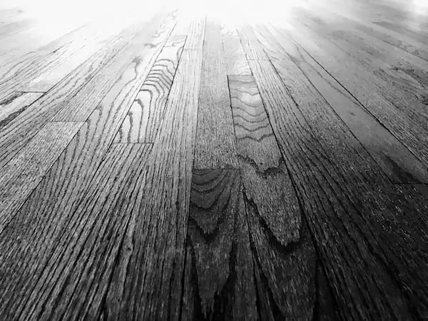 Close up of refinished hardwood floor grain showing restoration quality and dustless sanding results