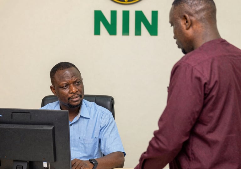 A professional consultant assisting a client with NIN registration paperwork.