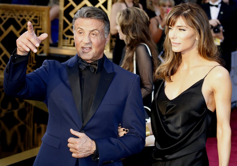 sylvester stallone in blue suit with wife