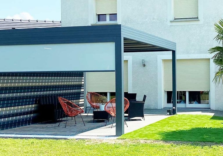 a patio with a table and chairs in the grass