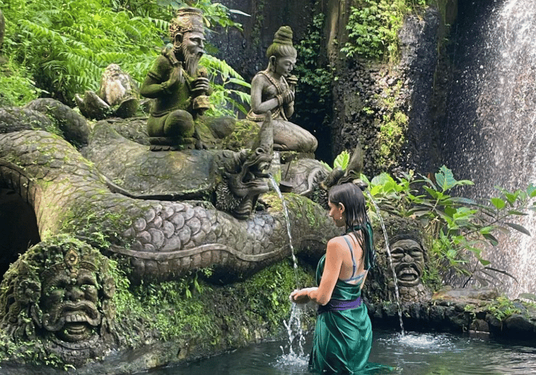 Woman bathing at a Bali waterfall. Highlights the spiritual travel a visa enables.