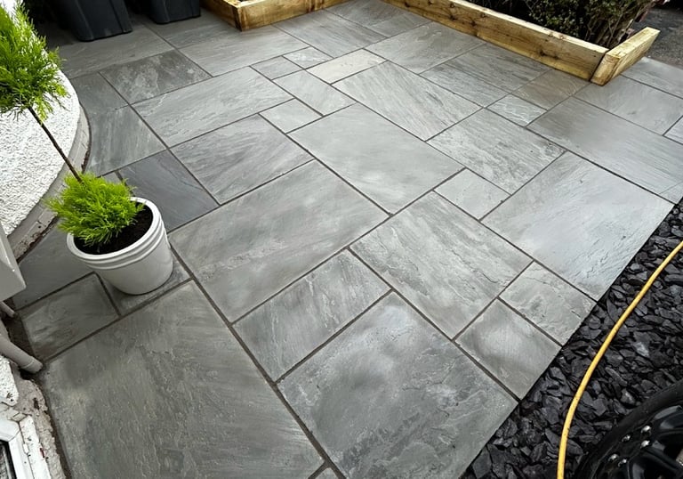 Blackpool garden paved with different sized flagging