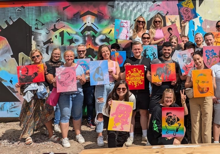 Team holding artwork after graffiti workshop in Hamburg, Team zeigt Kunst nach Street Art Workshop und Teambuilding Event