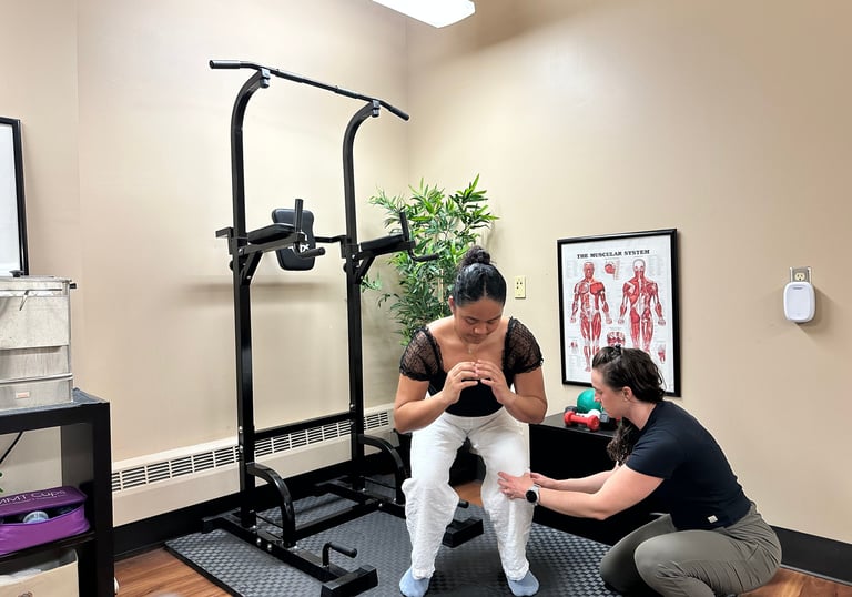 Chiropractor correcting patient's knee position in a squat.