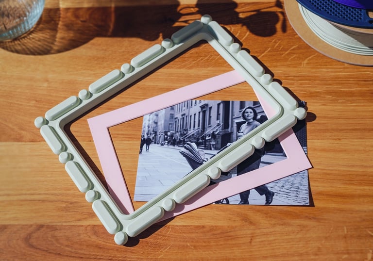 3D printable photo frame sizes shown top view with image and colored mat on desk
