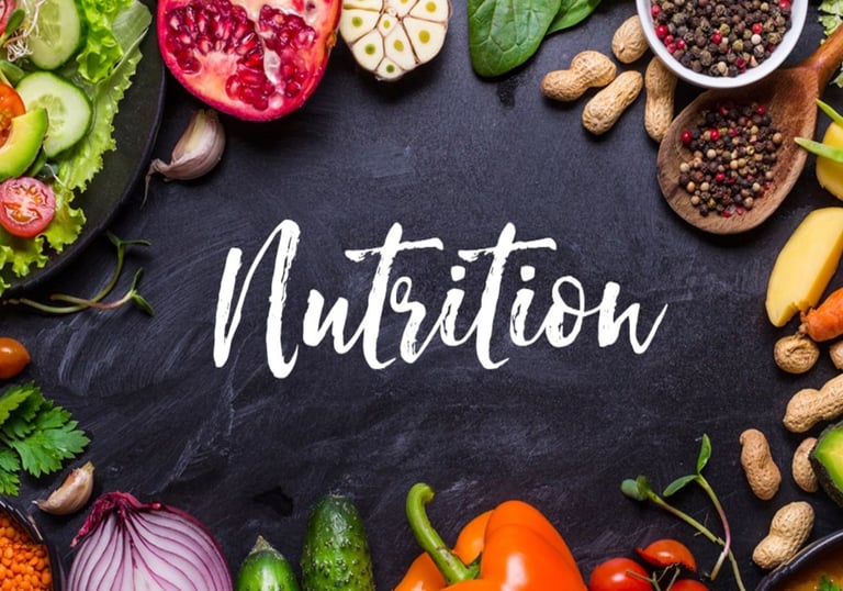 Black table featuring the word “Nutrition” in large letters, surrounded by a variety of foods for display.