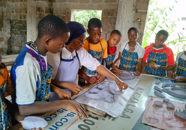 Students and teacher working on an artwork in an outdoor art class for creative skill building.