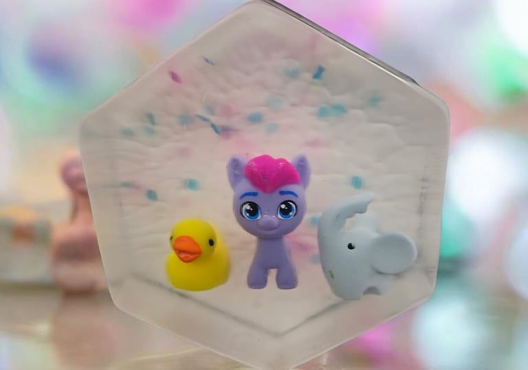 Handmade kids soap bar with colorful toy pony, rubber duck, and elephant inside, fun surprise soap