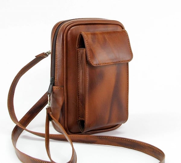 a brown leather baguet bag with a strap