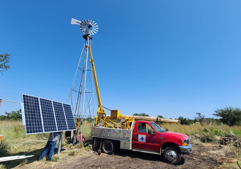 a truck, a windmill, and a solar panel